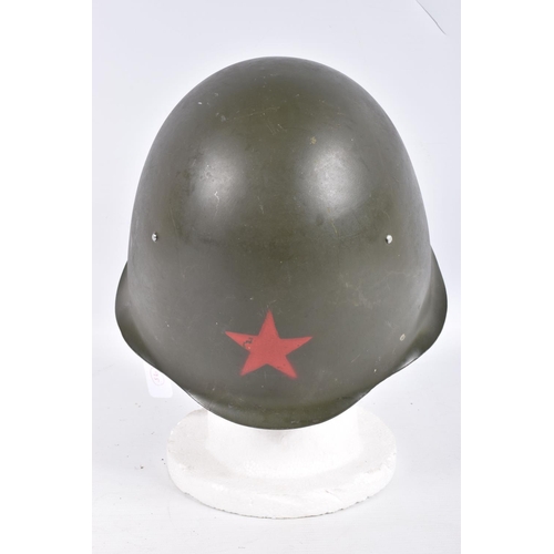 464 - A RUSSIAN COLD WAR ERA STEEL HELMET, it is green in colour and features a red star on the front, the... 