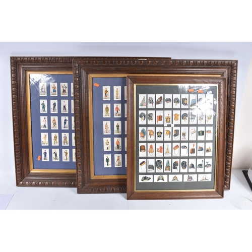 472 - THREE FRAMED AND GLAZED DISPLAYS OF CIGARETTE CARDS FEATURING BRITISH ARMY UNIFORMS AND HEADDRESS, t... 