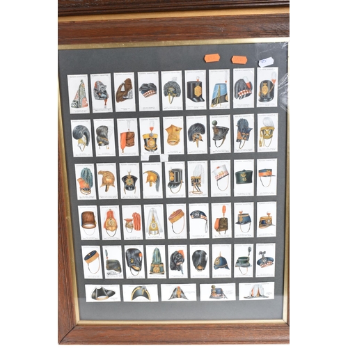 472 - THREE FRAMED AND GLAZED DISPLAYS OF CIGARETTE CARDS FEATURING BRITISH ARMY UNIFORMS AND HEADDRESS, t... 