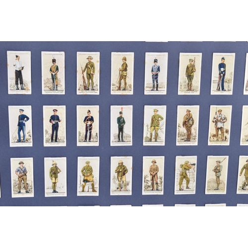 472 - THREE FRAMED AND GLAZED DISPLAYS OF CIGARETTE CARDS FEATURING BRITISH ARMY UNIFORMS AND HEADDRESS, t... 