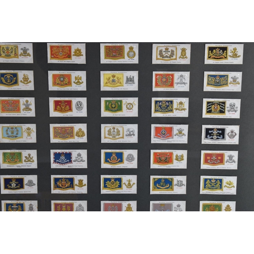 473 - THREE FRAMED AND GLAZED DISPLAYS OF MILITARY CAP BADGES AND KINGS COLOURES, the cards include one fr... 