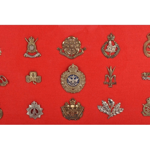 476 - TWO LARGE FRAMED AND GLAZED SETS OF MILITARY CAP BADGES, the badges cover different eras and include... 