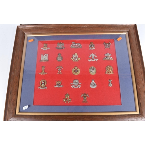 476 - TWO LARGE FRAMED AND GLAZED SETS OF MILITARY CAP BADGES, the badges cover different eras and include... 