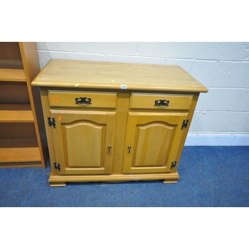 1247 - A MODERN BEECH EFFECT CABINET, with two drawers over two cupboard doors, width 98cm x depth 48cm x h... 