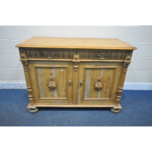 1250 - A 19TH CENTURY PINE DRESSER BASE, with two drawers, over two cupboard doors, with foliate carved mas... 