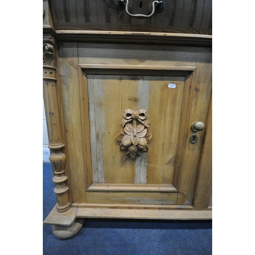 1250 - A 19TH CENTURY PINE DRESSER BASE, with two drawers, over two cupboard doors, with foliate carved mas... 