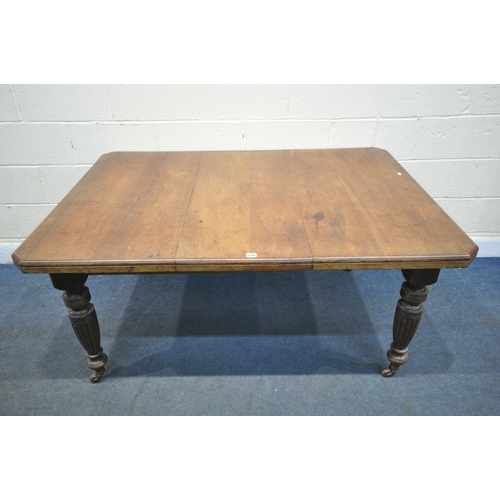 1298 - AN EDWARDIAN CENTURY WALNUT WIND OUT DINING TABLE, with one additional leaf, open length 148cm x clo... 