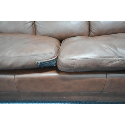 1303 - A BROWN LEATHER THREE SEATER SOFA, and an armchair (condition report: in need of a clean, other wear... 