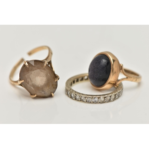 11 - THREE GEM SET RINGS, to include a blue goldstone cabochon ring, collet set to the bifurcated shoulde... 