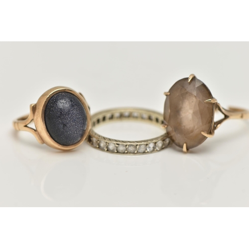 11 - THREE GEM SET RINGS, to include a blue goldstone cabochon ring, collet set to the bifurcated shoulde... 