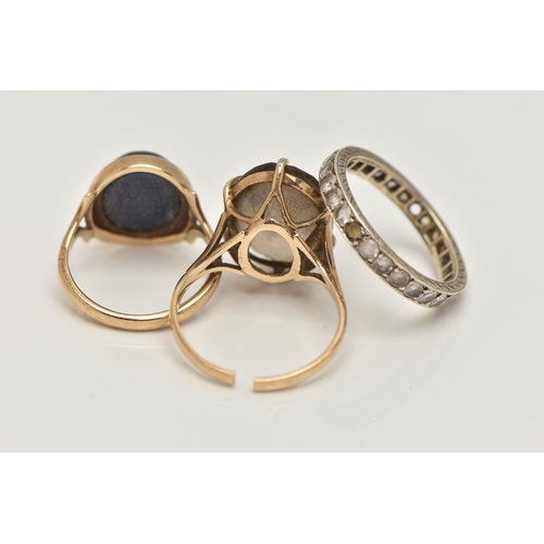 11 - THREE GEM SET RINGS, to include a blue goldstone cabochon ring, collet set to the bifurcated shoulde... 