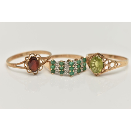 12 - THREE GEM SET RINGS, to include an emerald and diamond cluster ring, rubbed 9ct hallmark, ring size ... 