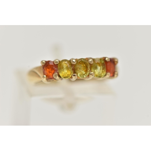 16 - A 9CT GOLD GEM SET RING, designed as a line of oval cut gems, the central three assessed as possibly... 