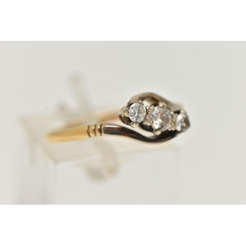 22 - A THREE STONE CROSSOVER DIAMOND RING, designed as a diagonal line of three brilliant cut diamonds in... 