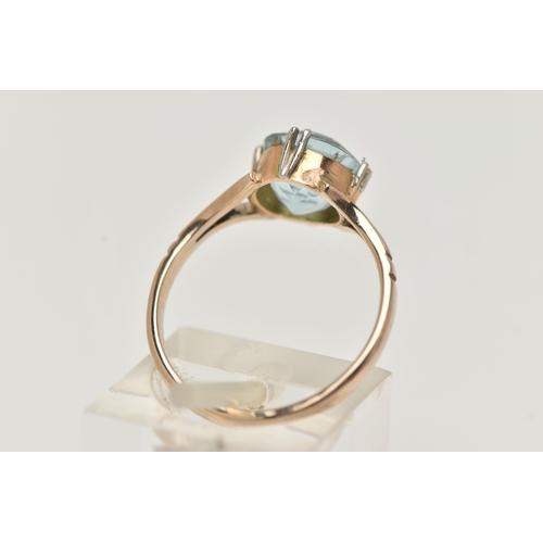 23 - AN AQUAMARINE RING, designed as a circular cut aquamarine in a double four claw setting to the bifur... 