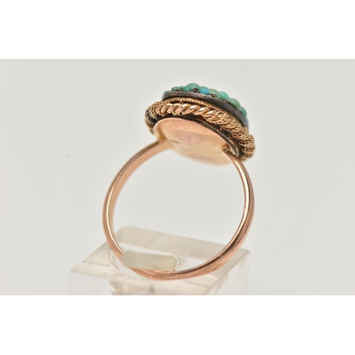 24 - A TURQUOISE RING, the oval panel set with circular turquoise cabochons, some replacements, to the ro... 