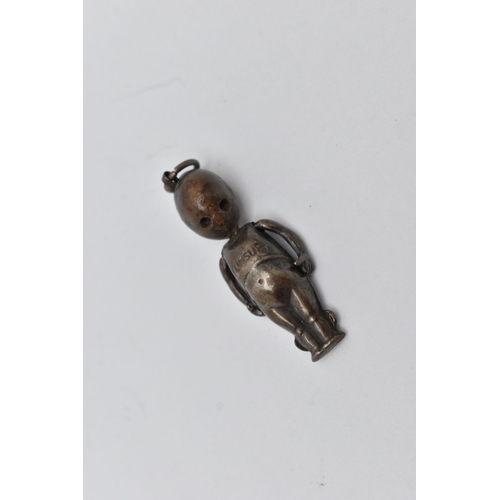 53 - A WHITE METAL FUMBSUP CHARM, an early 20th century WWI charm with kinetic arms, approximate length 3... 