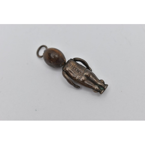 53 - A WHITE METAL FUMBSUP CHARM, an early 20th century WWI charm with kinetic arms, approximate length 3... 