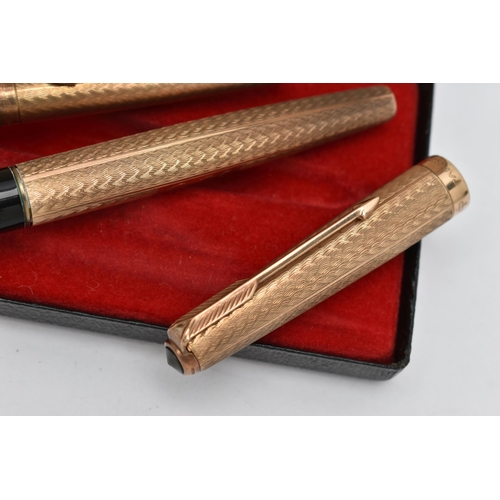 62 - A 9CT GOLD 'PARKER' FOUNTAIN PEN AND PENCIL, engine turned pattern, monogram engraving to the cartou... 