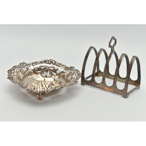 102 - A LATE VICTORIAN SILVER DISH AND A TOAST RACK, the heart shape bonbon dish with scrolling decoration... 