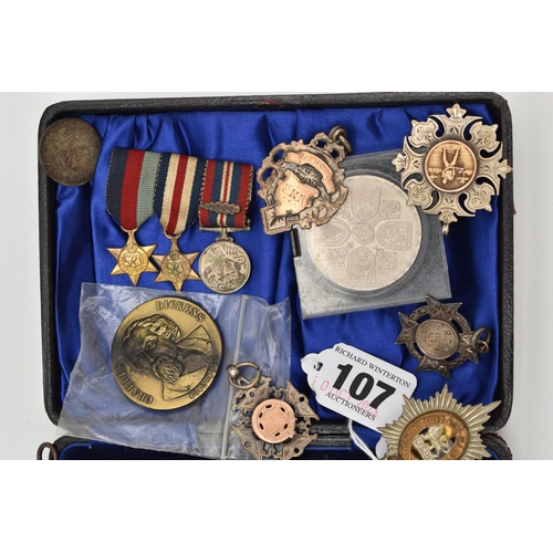 107 - A SMALL ASSORTMENT OF MEDALS AND COINS, to include three silver and yellow metal medals, each hallma... 