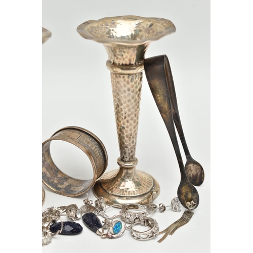 110 - A SMALL ASSORTMENT OF SILVER ITEMS, to include a pair of weighted base posey vases, a silver napkin ... 