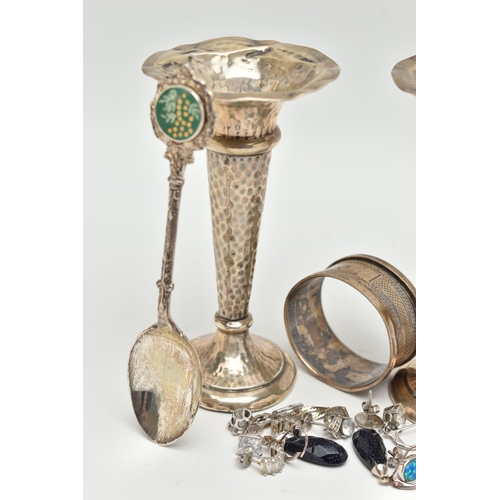 110 - A SMALL ASSORTMENT OF SILVER ITEMS, to include a pair of weighted base posey vases, a silver napkin ... 