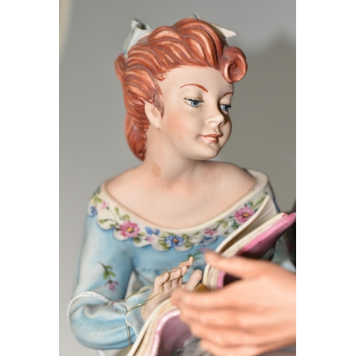 333 - A CAPODIMONTE FIGURE GROUP 'THE YOUNG STORY TELLER', by Germano Cortese, as a young girl kneeling an... 