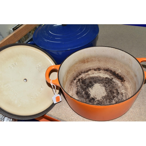 354 - TWO LE CREUSET CASSEROLE DISHES, comprising a Volcanic orange 22cm dish and a deep blue 24cm example... 