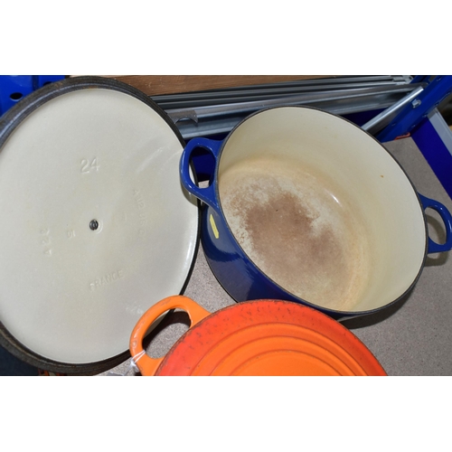 354 - TWO LE CREUSET CASSEROLE DISHES, comprising a Volcanic orange 22cm dish and a deep blue 24cm example... 