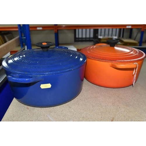 354 - TWO LE CREUSET CASSEROLE DISHES, comprising a Volcanic orange 22cm dish and a deep blue 24cm example... 