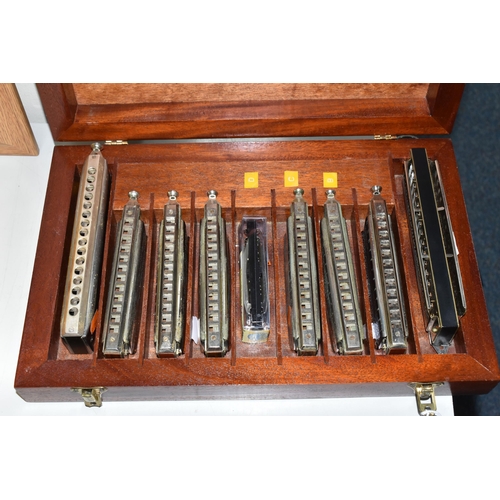 400 - A WOODEN CASE CONTAINING NINE HARMONICAS, comprising an M Hohner The 64 Chromonica, six The Super Ch... 