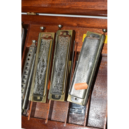 400 - A WOODEN CASE CONTAINING NINE HARMONICAS, comprising an M Hohner The 64 Chromonica, six The Super Ch... 