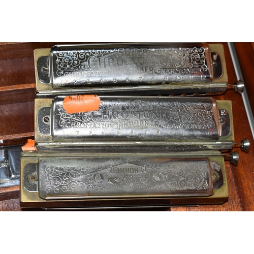 400 - A WOODEN CASE CONTAINING NINE HARMONICAS, comprising an M Hohner The 64 Chromonica, six The Super Ch... 