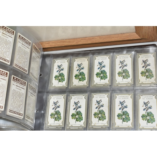 403 - TWO CIGARETTE CARD ALBUMS AND A BOX OF CIGARETTE CARDS containing a miscellaneous collection of sets... 