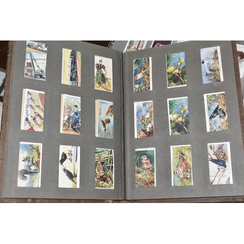 403 - TWO CIGARETTE CARD ALBUMS AND A BOX OF CIGARETTE CARDS containing a miscellaneous collection of sets... 