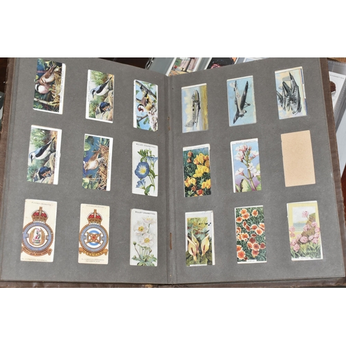 403 - TWO CIGARETTE CARD ALBUMS AND A BOX OF CIGARETTE CARDS containing a miscellaneous collection of sets... 