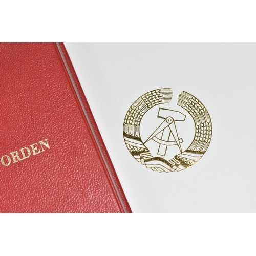 404 - A FOLDER AND A MEDAL BOX (empty) both embossed on the front with 'Karl Marx Orden'