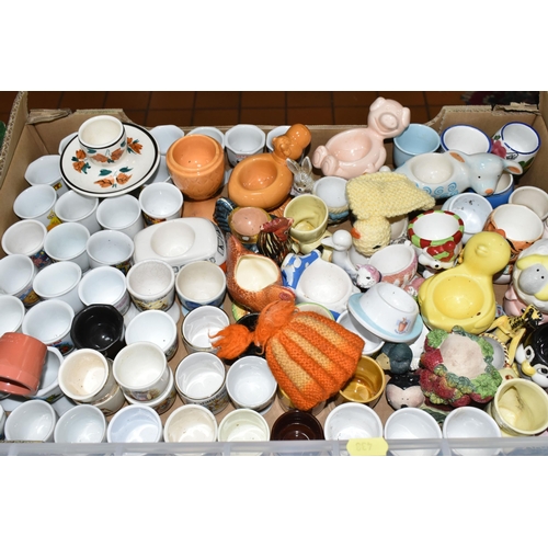 438 - EIGHT BOXES CONTAINING A LARGE COLLECTION OF CERAMIC EGG CUPS, to include over three hundred assorte... 