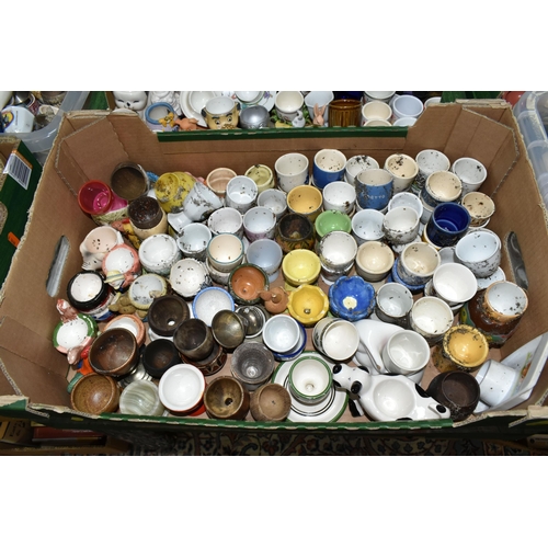 438 - EIGHT BOXES CONTAINING A LARGE COLLECTION OF CERAMIC EGG CUPS, to include over three hundred assorte... 