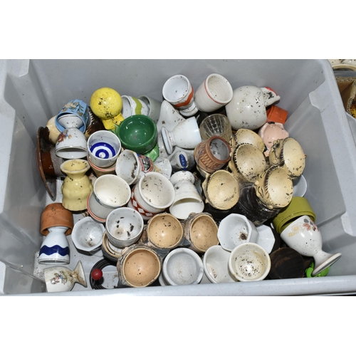 438 - EIGHT BOXES CONTAINING A LARGE COLLECTION OF CERAMIC EGG CUPS, to include over three hundred assorte... 