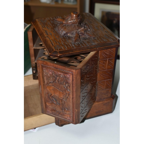 415 - A BLACK FOREST SMOKER'S CABINET, applied hunting equipment and guns in high relief, rising lid to to... 