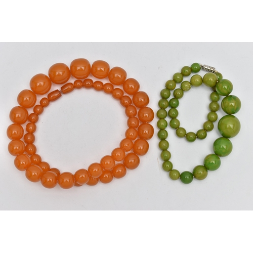 1244A - TWO EARLY TO MID 20TH CENTURY BAKELITE BEAD NECKLACES, the first a single row of circular orange bea... 