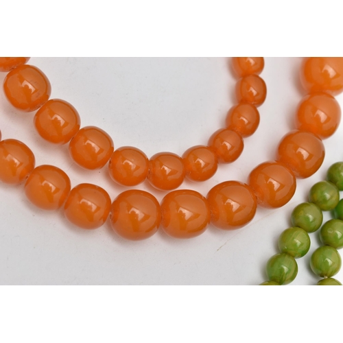 1244A - TWO EARLY TO MID 20TH CENTURY BAKELITE BEAD NECKLACES, the first a single row of circular orange bea... 