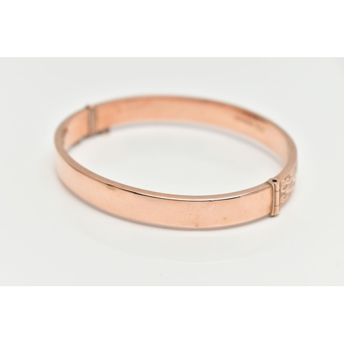 20 - A EARLY 20TH CENTURY HINGED BANGLE, to include a rose gold flat hinged bangle with embossed floral a... 