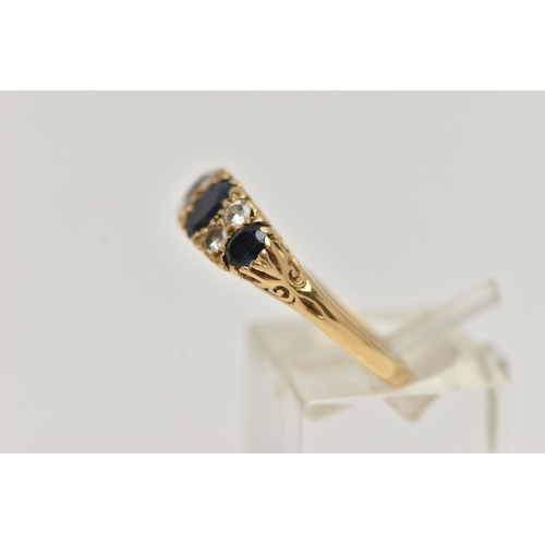 32 - A YELLOW METAL SAPPHIRE AND DIAMOND RING, set with three oval cut deep blue sapphires, interspaced w... 