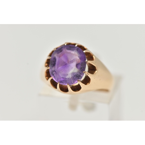 4 - A YELLOW METAL AMETHYST RING, oval cut amethyst, prong set in yellow metal, leading on to a tapered ... 