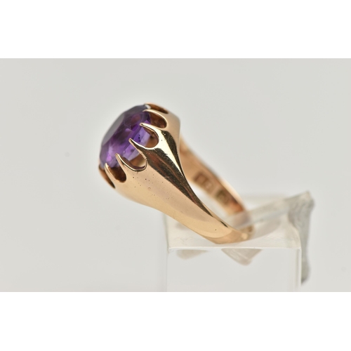 4 - A YELLOW METAL AMETHYST RING, oval cut amethyst, prong set in yellow metal, leading on to a tapered ... 