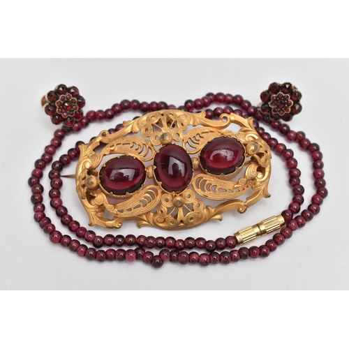 40 - THREE PIECES OF JEWELLERY, to include a large base metal open work brooch set with three oval cut re... 