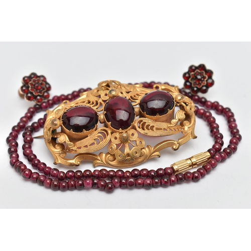 40 - THREE PIECES OF JEWELLERY, to include a large base metal open work brooch set with three oval cut re... 